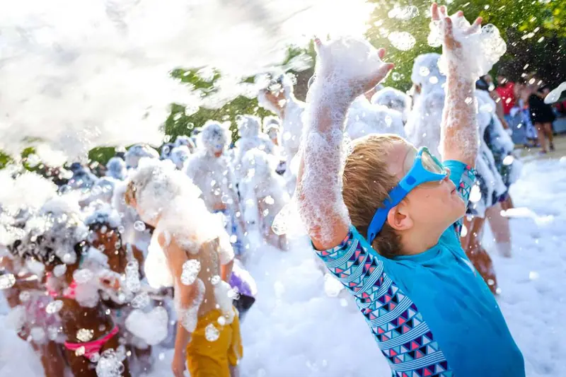 Kids playing at a Millers Jump Time foam party