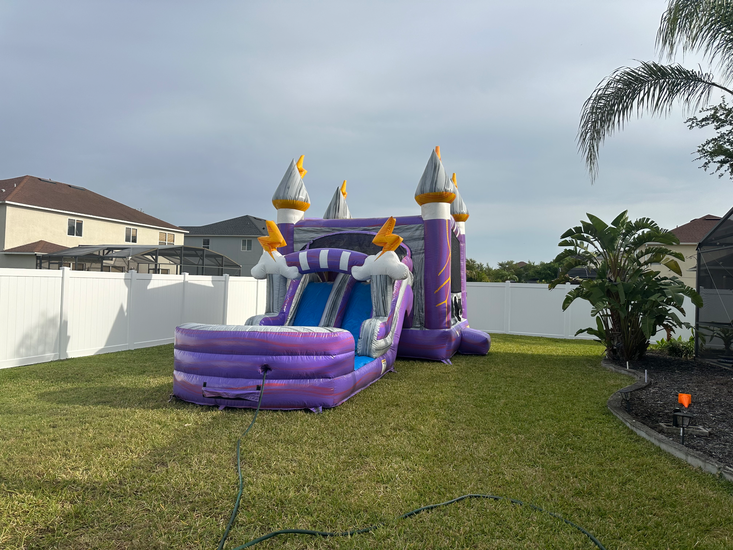 Lightning purple slide and round pool beside a house