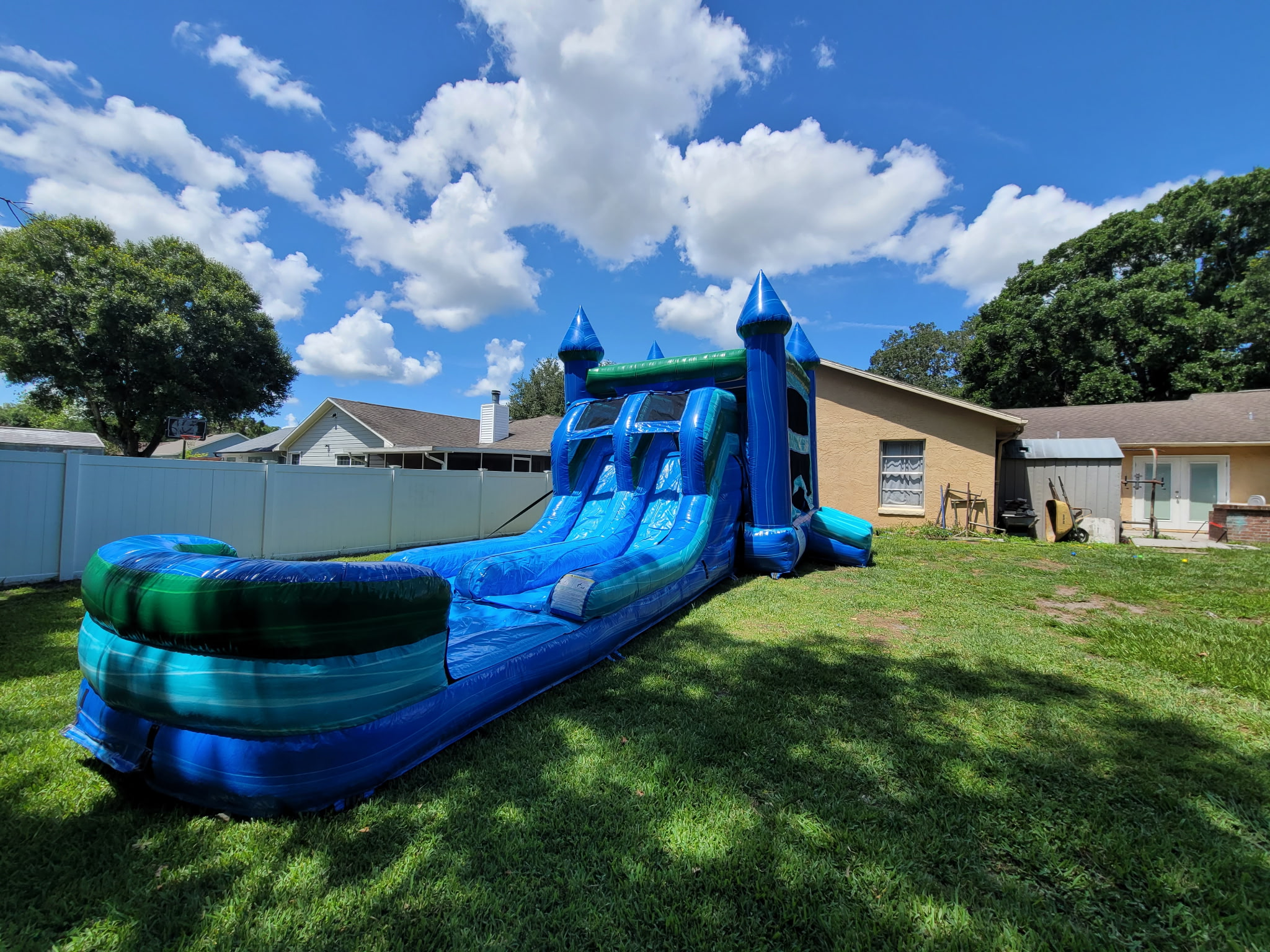 XL Noah's Ark blue and turquoise castle and slide beneath trees