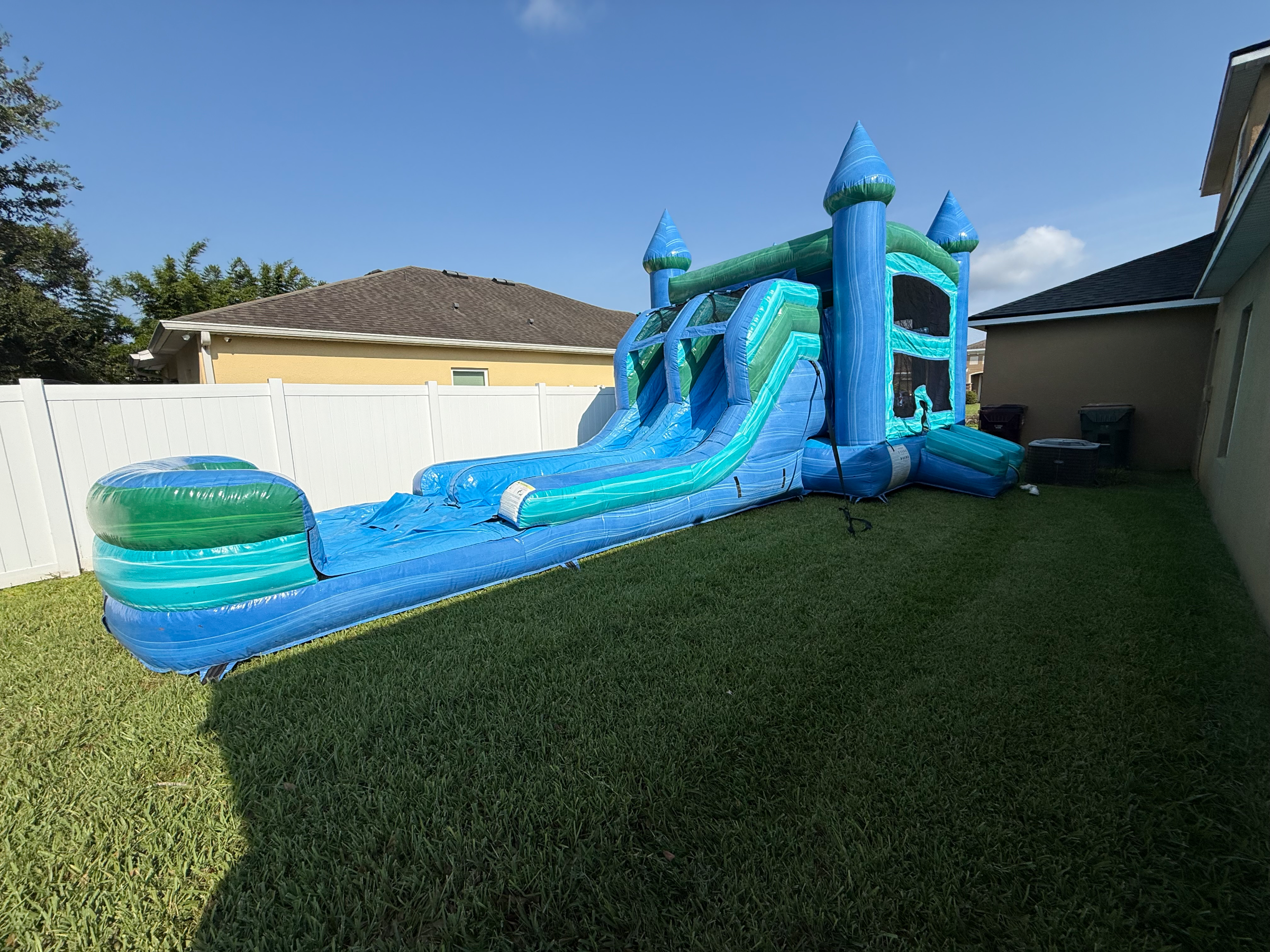 XL Noah's Ark blue and turquoise bounce house with double slide and pool on grass