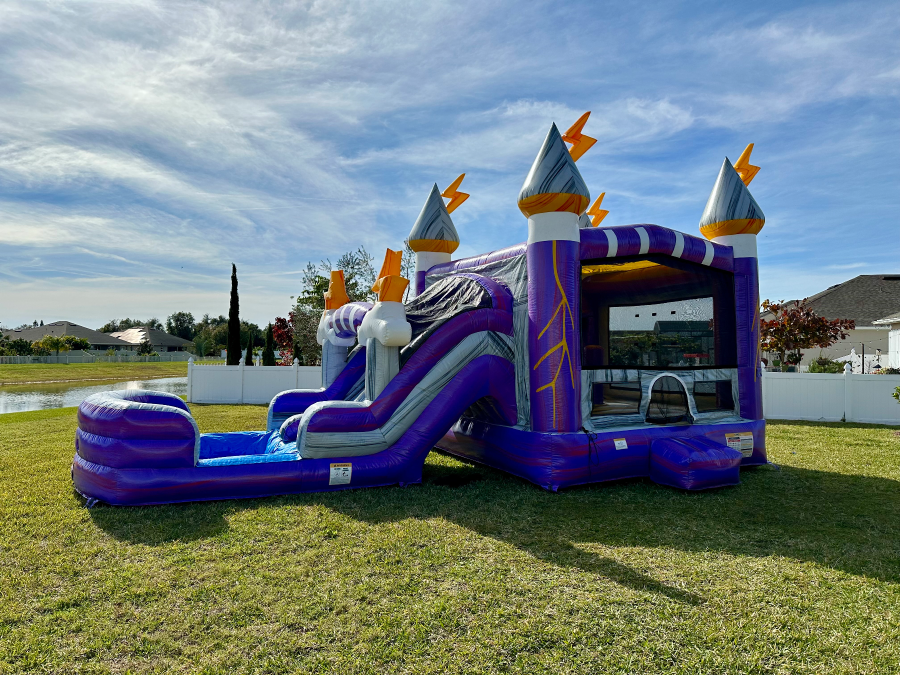 Side view of Lightning's purple castle, slide and splash landing on grass