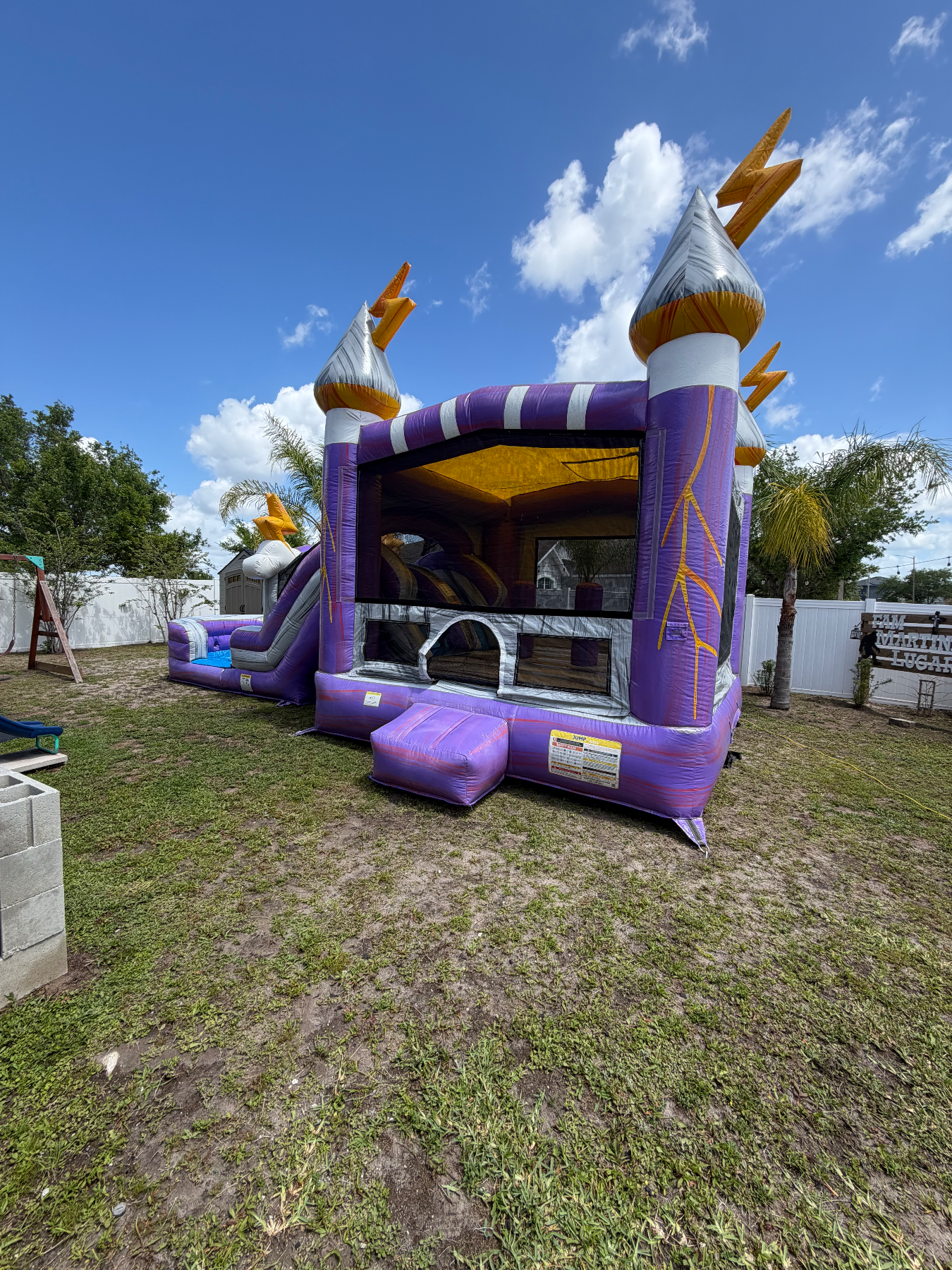 Front of Lightning's purple bounce house with silver towers and lightning decorations