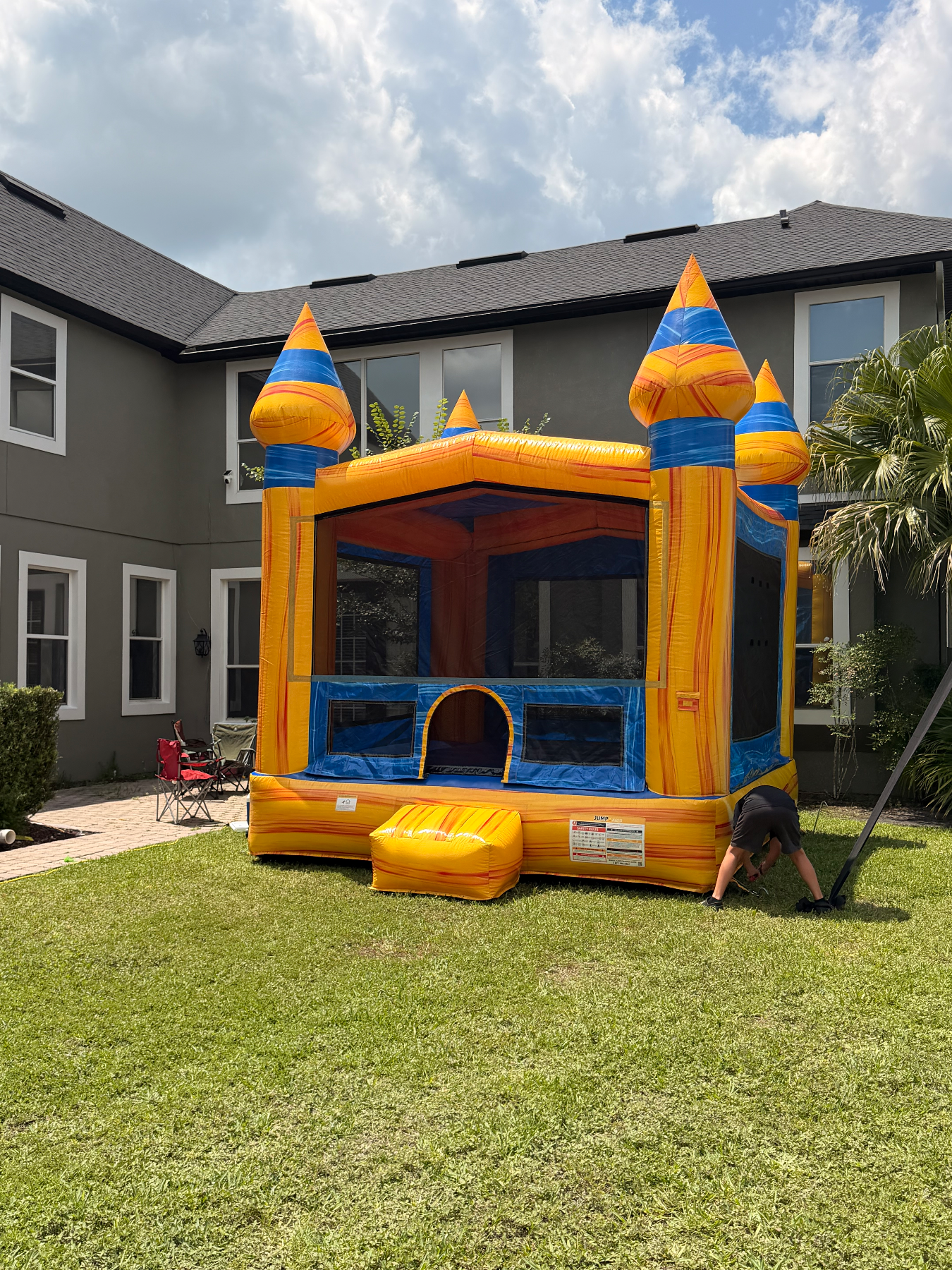 Volcano yellow towers and blue mesh frames in a residential backyard