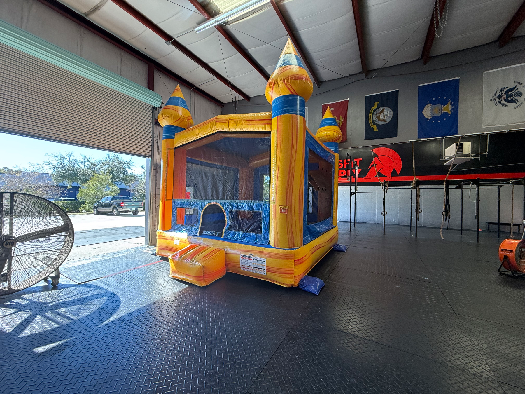 Volcano yellow and blue castle bounce house inside a covered event hall
